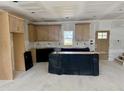 Unfinished kitchen with wooden cabinets and an island, ready for customization at 902 Norwood Ln, Apex, NC 27502