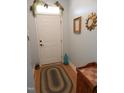Welcoming entryway with neutral paint, wood floors, and decorative accents at 903 Teague Pl, Durham, NC 27707