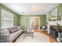 Cozy living room with fireplace, stylish furnishings, and a view into the dining area at 914 S Crescent Dr, Smithfield, NC 27577