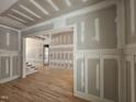 Partially-constructed living room with decorative wall panels and hardwood floors awaiting finishing touches at 98 Fox Oak Trl, Pittsboro, NC 27312