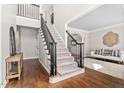 Grand foyer with an elegant staircase, hardwood floors, and decorative wall accents at 101 Listokin Ct, Cary, NC 27519