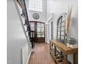 Inviting foyer boasts hardwood floors, a striking staircase, and a decorative wooden table at 101 Listokin Ct, Cary, NC 27519
