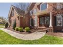 Beautiful brick home features a covered entryway, manicured landscaping, and a welcoming walkway at 101 Listokin Ct, Cary, NC 27519
