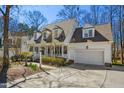 Beautiful exterior featuring manicured landscaping, attached garage, and quaint front porch at 102 Battenburg Ct, Cary, NC 27519