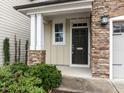 Inviting front entrance with stone accents, green bushes and a covered porch at 105 Concordia Woods Dr, Morrisville, NC 27560