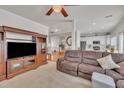 Open-concept living area with cozy brown sofa, large TV, and open access to the kitchen at 10707 Edmundson Ave, Raleigh, NC 27614