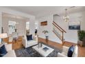 Bright living room with hardwood floors, white furnishings, and stylish decor at 10707 Edmundson Ave, Raleigh, NC 27614
