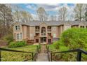 Attractive multi-story apartment with brick accents and private balconies in a serene, wooded setting at 109 Killam Ct # La, Cary, NC 27513