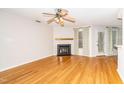 Spacious living room featuring hardwood floors, a cozy fireplace, and natural light at 109 Killam Ct # La, Cary, NC 27513