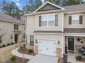 A lovely home showcasing a garage, stone accents, and manicured landscaping at 1103 Apogee Dr, Durham, NC 27713