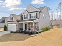 Beautiful two-story home with gray siding and a stone foundation, featuring a well-maintained lawn at 115 Cliffview Dr, Garner, NC 27529