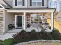 Inviting front porch with a bench swing, stone accents, and a welcoming entrance to the home at 115 Cliffview Dr, Garner, NC 27529