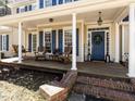 Welcoming front porch with a swing, rocking chairs, and a decorative blue door at 11619 John Allen Road Rd, Raleigh, NC 27614