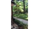 View of a backyard, lush greenery, and mature trees at 11912 Appaloosa E, Raleigh, NC 27613