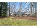 Well-maintained brick home featuring a manicured lawn and mature trees at 11912 Appaloosa E, Raleigh, NC 27613