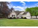 Attractive single-story home featuring a well-kept lawn and manicured landscaping at 129 Bennett Pl, Clayton, NC 27527