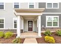 Inviting front entryway with a classic covered porch, stone accents, and decorative landscaping enhances curb appeal at 1434 Rosepine Dr, Cary, NC 27519