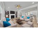 Bright living room with a fireplace, built-in shelving, neutral furniture, and open access to the kitchen at 1434 Rosepine Dr, Cary, NC 27519