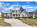 View of the well-manicured lawn and the long concrete driveway of this traditional home at 147 Tralee Dr, Smithfield, NC 27577