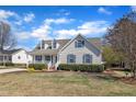 Attractive single-Gathering home featuring dormer windows, shutters, and a cozy front porch at 147 Tralee Dr, Smithfield, NC 27577