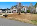 Exterior view of a single-story home with a well-manicured lawn and an attached two-car garage at 153 Brindley Cir, Clayton, NC 27520