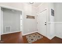 Welcoming foyer with hardwood floors, a decorative rug, and neutral wall colors at 153 Brindley Cir, Clayton, NC 27520