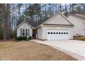 Charming single-story home with well-maintained lawn, attached garage and mature trees at 1603 Stonegate S, Sanford, NC 27332