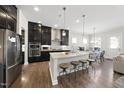 Modern kitchen with stainless steel appliances, granite countertops, and a center island with seating at 1628 Highpoint St, Wake Forest, NC 27587