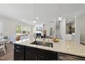 Open-concept kitchen with granite countertops and seamless flow into the living room at 1628 Highpoint St, Wake Forest, NC 27587