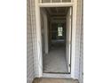 An entryway with an open door, gray walls and unfinished flooring and a view to another room at 200 Dove Rd, Cameron, NC 28326