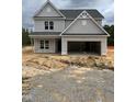 Two-story home featuring a gray exterior, a two-car garage and unfinished landscaping at 200 Dove Rd, Cameron, NC 28326