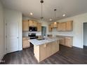 Bright kitchen with a granite island, stainless steel appliances, and stylish pendant lighting at 274 Longbow Dr, Middlesex, NC 27557