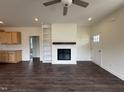 Cozy living room with a fireplace, built-in shelving, and hardwood floors at 274 Longbow Dr, Middlesex, NC 27557