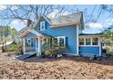 Charming two-story home featuring a covered porch and a well-maintained yard with mature trees at 290 Collie Rd, Castalia, NC 27816