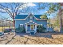Charming two-story home featuring a covered front porch and a well-maintained yard at 290 Collie Rd, Castalia, NC 27816