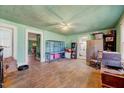 Spacious living room with hardwood floors, large windows, and vintage decor creating a cozy atmosphere at 290 Collie Rd, Castalia, NC 27816