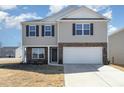 Charming two-story home with stone accents, attached two-car garage, and well-maintained lawn at 2902 Cullens Dr, Graham, NC 27253