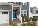 Close up of a beautiful front door with colorful wreath and white trim at 3727 Horton Hill Dr, New Hill, NC 27562