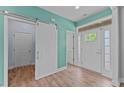 Bright entryway with hardwood floors, sliding barn door, and ample natural light at 385 Ashberry Ln, Franklinton, NC 27525
