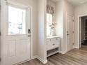 Inviting foyer featuring a white front door, stylish console table, and light-colored wood floors at 4000 Passenger Pl, Durham, NC 27703