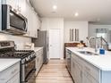 Well-equipped kitchen with stainless appliances, white countertops, and ample cabinet space at 4000 Passenger Pl, Durham, NC 27703