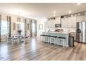 Open-concept kitchen and dining area featuring an island with seating, stainless appliances, and modern finishes at 4000 Passenger Pl, Durham, NC 27703