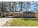Charming brick home featuring a covered carport and front yard at 417 Baker St, Nashville, NC 27856