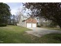 Beautiful home exterior with well-maintained lawn and mature trees offering privacy at 4336 N Greg Allen Way, Oxford, NC 27565