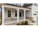 Inviting front porch with white railing, brick accents, and well-manicured landscaping at 505 Marion Hills Way, Knightdale, NC 27545
