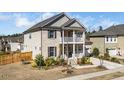 Charming two-story home with a cozy front porch and well-manicured lawn at 518 Parlier Dr # 82, Apex, NC 27523