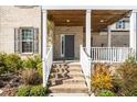 Inviting front porch with steps leading to the entrance and manicured landscaping at 518 Parlier Dr # 82, Apex, NC 27523