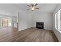 Bright living room features a fireplace, high ceilings, modern flooring, and open floor plan at 5408 Rivercrest Dr, Youngsville, NC 27596