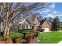 Beautiful brick home featuring lush landscaping, a bay window and mature trees at 5624 Bennettwood Ct, Raleigh, NC 27612
