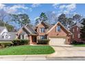 Charming brick home with a manicured lawn, shutters, and a two-car garage at 5624 Bennettwood Ct, Raleigh, NC 27612